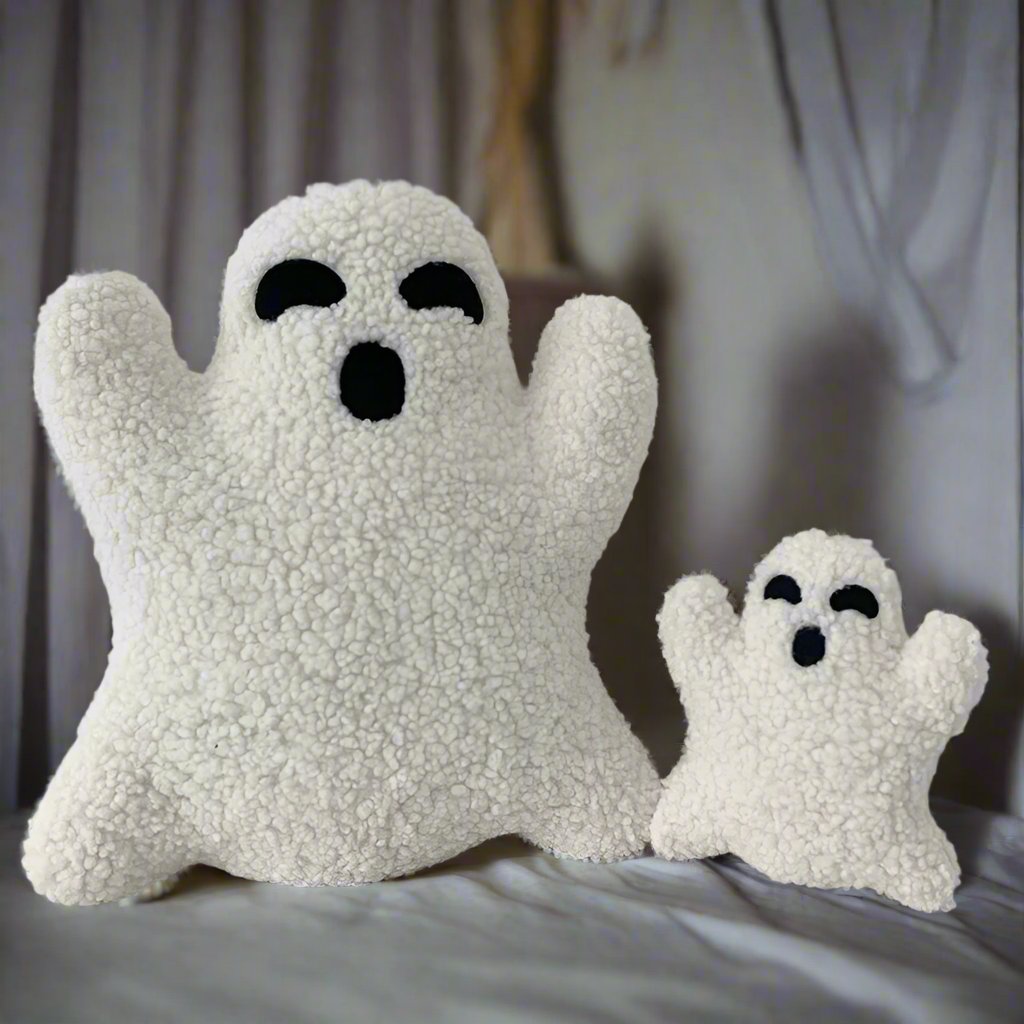 Boo Buddies plushies in two sizes placed on a bed in a cozy room setting, showing their cute ghost faces, Boo Buddies, Ghost plushies, Halloween decor, Soft and cuddly, Plushies, Cute Plush, Soft Toys, Stuffed Toys, Adorable, Huggable, Kids Toys, Gifts, Teddy Bears.