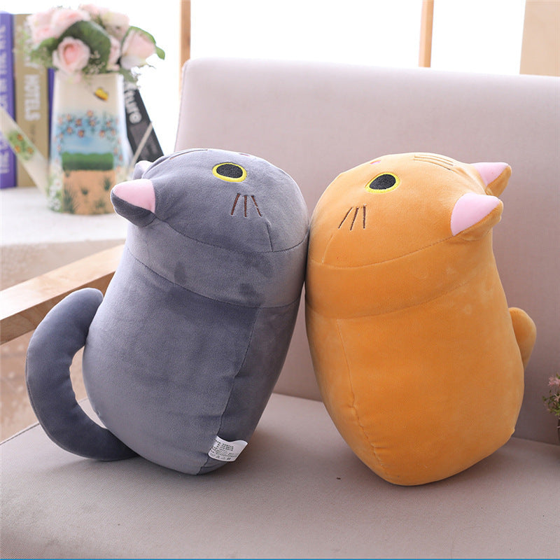 Grey and orange Purr Pals plushies sitting together on a sofa, showing their round shapes and cute cat faces, Purr Pals, Grey, Orange, Cat plushie, Plushies, Cute Plush, Soft Toys, Stuffed Toys, Adorable, Cuddly, Huggable, Kids Toys, Gifts.